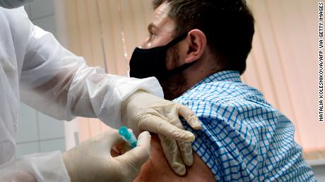 A nurse inoculates volunteer Ilya Dubrovin, 36, with Russia&#39;s new coronavirus vaccine in a post-registration trials at a clinic in Moscow on September 10, 2020. - Russia announced last month that its vaccine, named &quot;Sputnik V&quot; after the Soviet-era satellite that was the first launched into space in 1957, had already received approval. The vaccine was developed by the Gamaleya research institute in Moscow in coordination with the Russian defence ministry. (Photo by Natalia KOLESNIKOVA / AFP) (Photo by NATALIA KOLESNIKOVA/AFP via Getty Images)