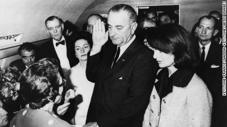Lyndon Johnson takes the oath of office aboard Air Force One on November 22, 1963.