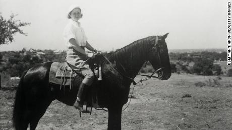 Lady Bird Johnson rides a horse on the Johnson family ranch in Texas in 1963.