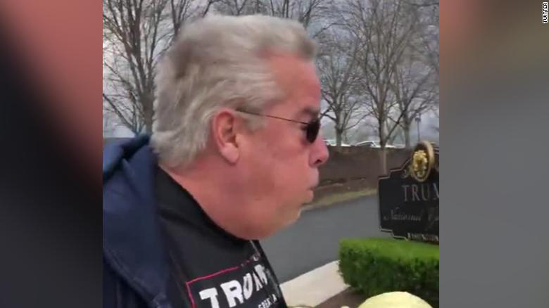 A man wearing Trump gear who was seen deliberately exhaling on women outside Trump golf club has been charged