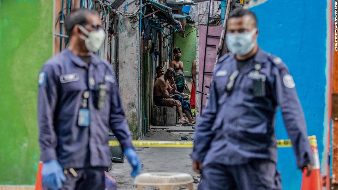 Security personnel in Malé stand guard outside a residential area for Bangladeshi workers, who were placed under coronavirus quarantine in May.
