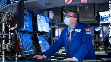 Specialist Patrick King works at the New York Stock Exchange on Monday, Nov. 23, 2020. Stocks rose in early trading Monday after investors received several pieces of encouraging news on COVID-19 vaccines and treatments, tempering concerns over rising virus cases and business restrictions.  (Nicole Pereira/New York Stock Exchange via AP)