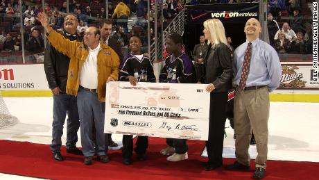 Fred Sasakamoose reacts as he is presented with a check for Johnny&#39;s Jems and Jets Hockey team during a ceremony celebrating at the United Center on October 19, 2002 in Chicago, Illinois. 