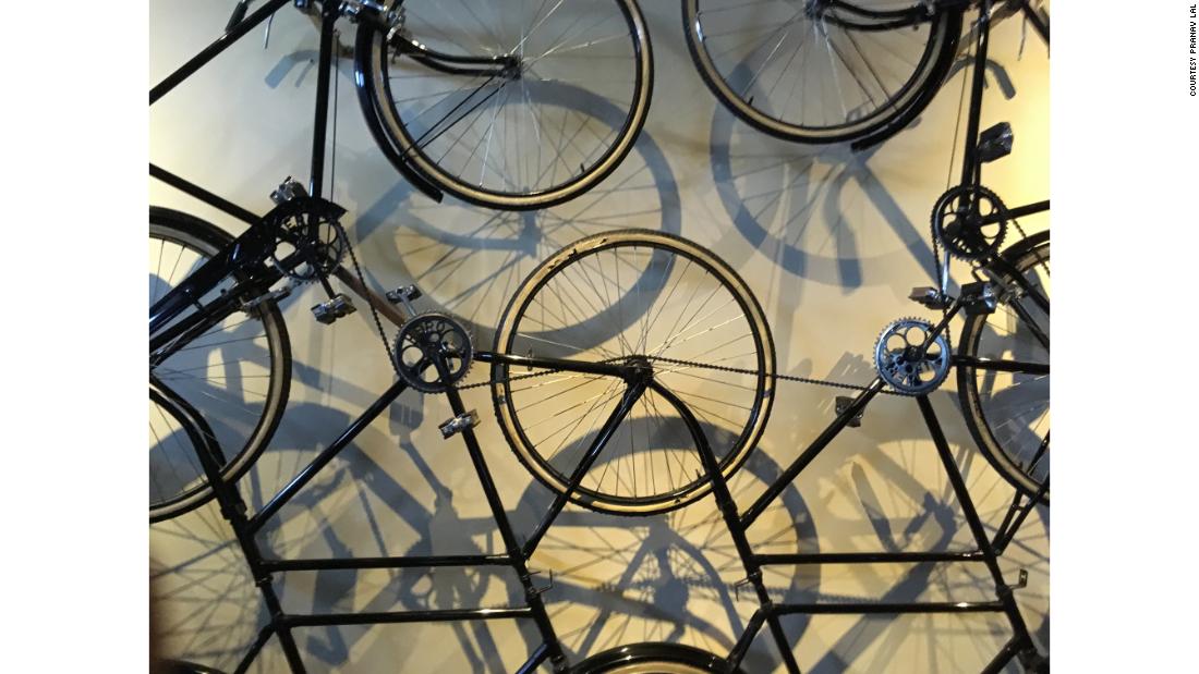 A bicycle installation hangs on a museum wall. &quot;Most of my work is with light, shadow and shape,&quot; says Lal.