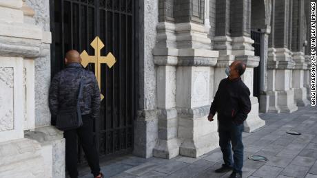 Two men look at St Joseph&#39;s Church, also known as Wangfujing Catholic Church, in Beijing on October 22, 2020.
