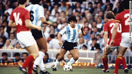 Maradona takes the Belgian defense at the 1982 World Cup.