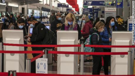 Travelers will check in at Chicago’s O’Hare International Airport on Wednesday.  Despite health officials being warned to stay home because of Covid-19, people continue to travel for Thanksgiving.