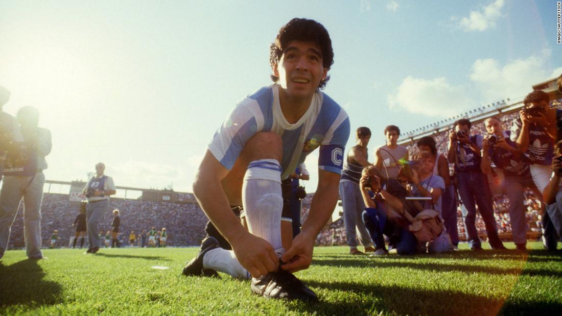 Maradona ties his shoelaces before a friendly game against West Germany in 1987.