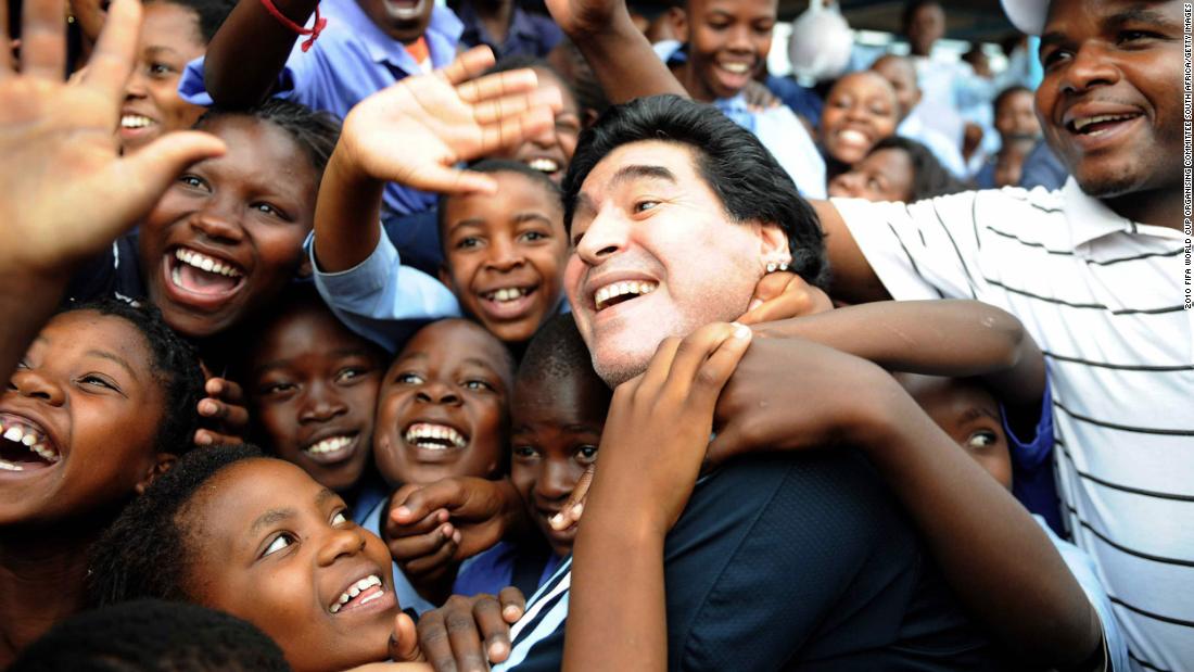 Maradona, as manager of Argentina&#39;s national team, is greeted by schoolchildren before the 2010 World Cup in South Africa.