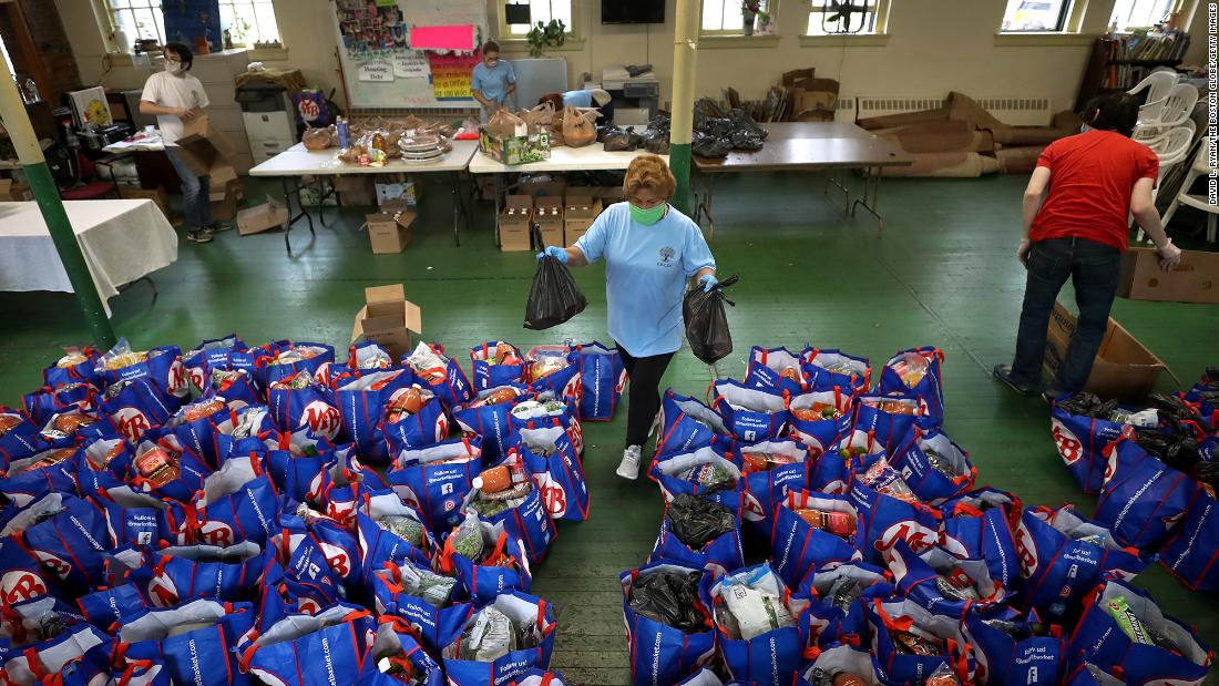 Paulina Bastidas-Yale helps distribute food at a Boston church in September.