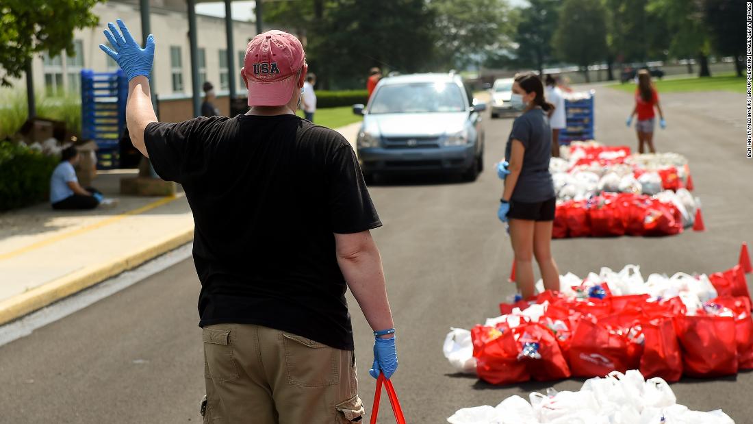 Volunteer Joseph Cunliffe holds a bag of bread to put in someone&#39;s car in Robesonia, Pennsylvania, in August.