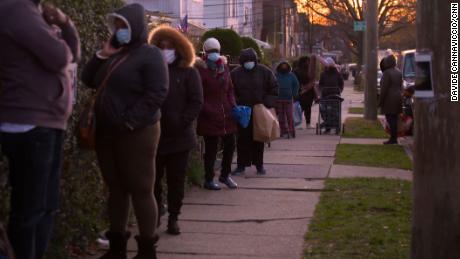 People wait in line to pick up food at Agatha House Foundation in the Bronx.