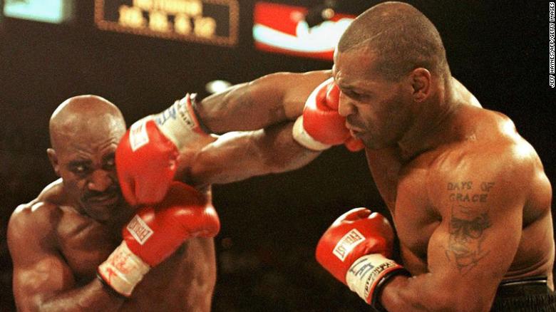 Evander Holyfield (L) and Mike Tyson (R) trade punches on June 28, 1997 in their WBA heavyweight Championship fight at the MGM Grand Garden Arena in Las Vegas.