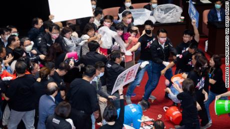 Kuomintang (KMT) lawmakers throw pig offal on the podium in Taiwan&#39;s parliament in Taipei, on November 27, 2020. 