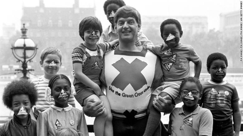 Dave Prowse in his role as the Green Cross Code Man, with students from Lambeth Johanna Primary School in London.