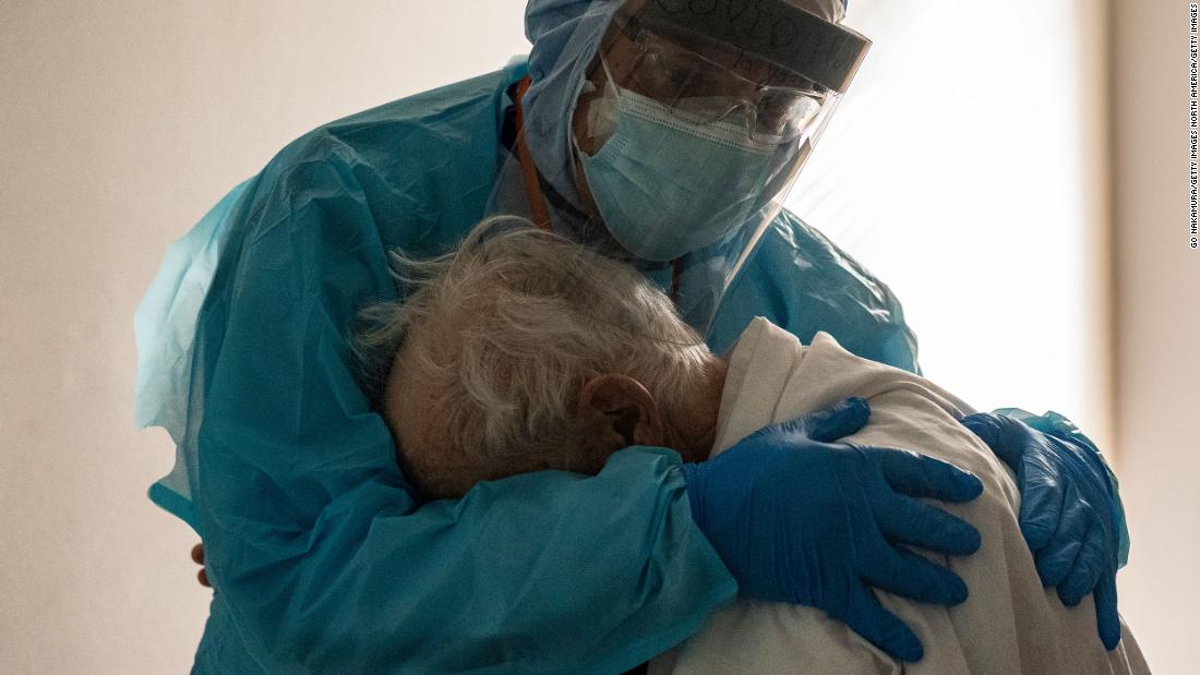 Dr. Joseph Varon comforts a patient on Thanksgiving Day in the Covid-19 intensive care unit at the United Memorial Medical Center in Houston.