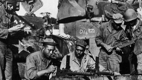 Soldiers from Dog Company of the 761st Tank Battalion--the first African-American tank battalion to go into battle. check equipment before leaving England for combat in France in the fall of 1944. 