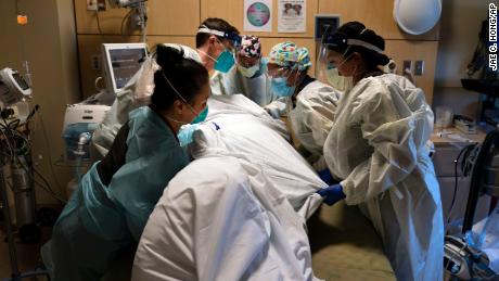 In this November 19, 2020, file photo, medical personnel prone a Covid-19 patient at Providence Holy Cross Medical Center in the Mission Hills section of Los Angeles.