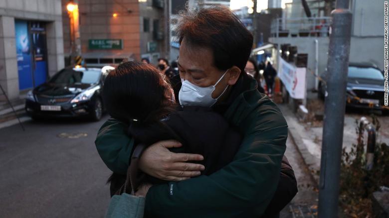 A father hugs on her daughter taking the college entrance exam amid the coronavirus pandemic on December 3, 2020 in Seoul, South Korea.