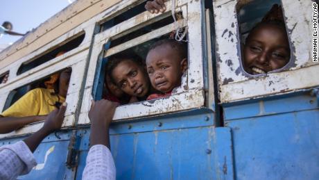 Tigray refugees who fled the conflict in northern Ethiopia ride a bus to a temporary shelter near the Sudan-Ethiopia border on Tuesday, December 1.