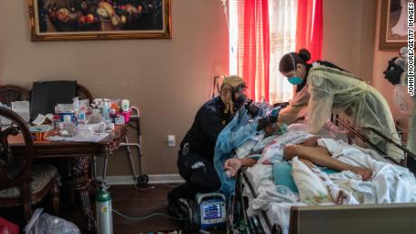 Emergency medical workers intubate a coronavirus patient at a home in Yonkers, New York, on April 6. The 92-year-old man was later put on a ventilator at the hospital, and he died two weeks later, his family said.