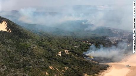 Smoke blows over hills and toward the ocean at Fraser Island, on Australia&#39;s east coast, where a fire has raged for six weeks.