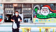 A customer gets his takeout order from a Los Angeles restaurant on Dec. 1. Restaurant and bar owners have protested the shutdown of outdoor dining.