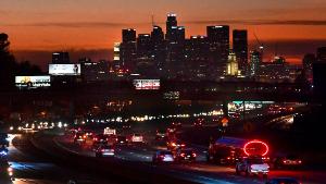 The evening rush hour commute flows past downtown Los Angeles, California on December 3, 2020. - California Governor Gavin Newsom on December 3 announced new statewide bans on gatherings and &quot;non-essential&quot; activities, as hospitals in the nation&#39;s most populous state face being overwhelmed by record Covid-19 cases. The limits will come into effect once 85 percent of intensive care unit beds have been filled -- a development expected in four of California&#39;s five regions &quot;as early as the next day or two.&quot; (Photo by Frederic J. BROWN / AFP) (Photo by FREDERIC J. BROWN/AFP via Getty Images)