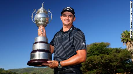 Christiaan Bezuidenhout poses with the trophy after his victory in the South African Open.