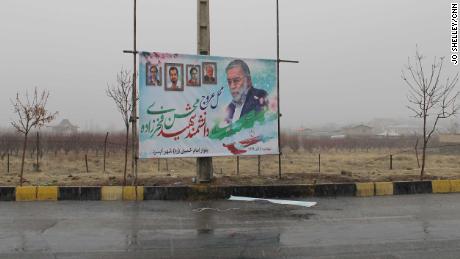 A poster of Mohsen Fakhrizadeh stands above the spot where he was gunned down outside Tehran. 