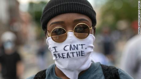 A protester wears a cloth mask stating &quot;I CAN&#39;T BREATHE&quot; amid widespread unrest after the death of George Floyd in Philadelphia.