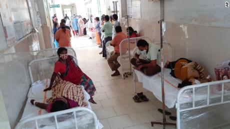 Patients and bystanders are seen at the district government hospital in Eluru, Andhra Pradesh state, India, on December 6.