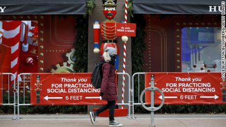 A pedestrian wearing a mask walks past a holiday display in downtown Toronto on Monday, November 23. Canada's largest province is under a lockdown to slow a second wave of coronavirus cases.