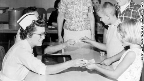 Children receive the polio vaccine on a sugar cube in the early 1960s.