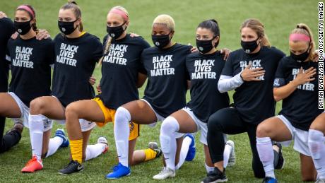 Utah Royals FC players wearing shirts in support for the Black Lives Matter movement kneel prior a game between Utah Royals FC and Houston Dash at Zions Bank Stadium on June 30, 2020.