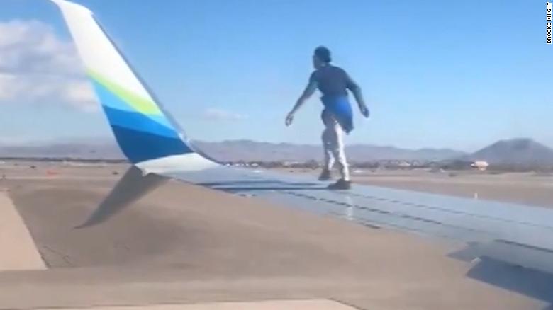 Video shows man walking on wing of plane before takeoff