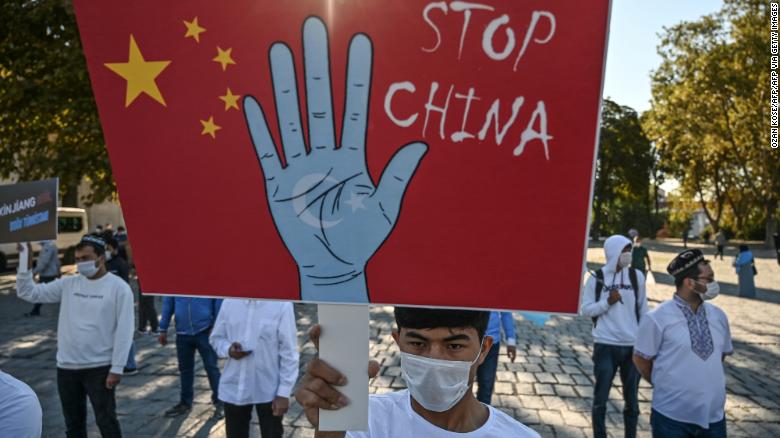 Supporters of China's Uyghur minority hold placards as they gather at the Beyazit Square on October 1, 2020 during a demonstration in Istanbul, Turkey.