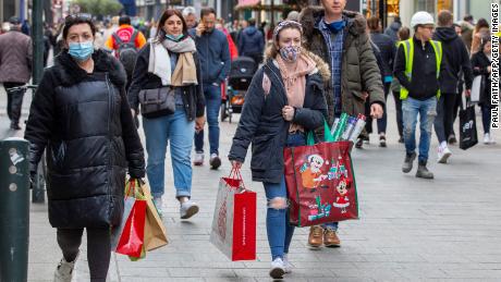 Pedestrians walk along a busy shopping street in Dublin on December 1