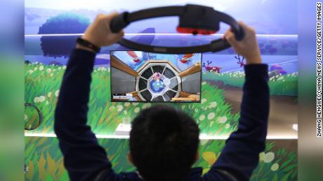 A visitor plays the Ring Fit Adventure game at the Nintendo booth during the Third China International Import Expo November 6 in Shanghai. 