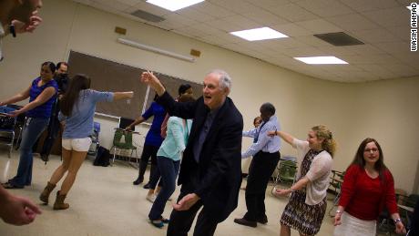 Alda works with students on an improv exercise.