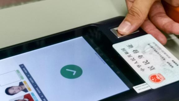A student scanning their second-generation "smart" ID card at an exam site in July 2020 in Nanchang city.