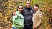 Philamena (left) smiles with her siblings, Phillip and Phillana Belone.
