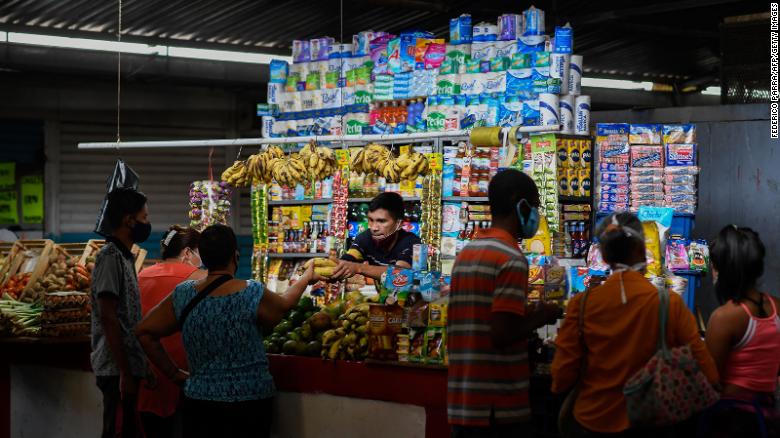 A vendor attends a stall at the municipal market of Chacao in Caracas on September 3, 2020.