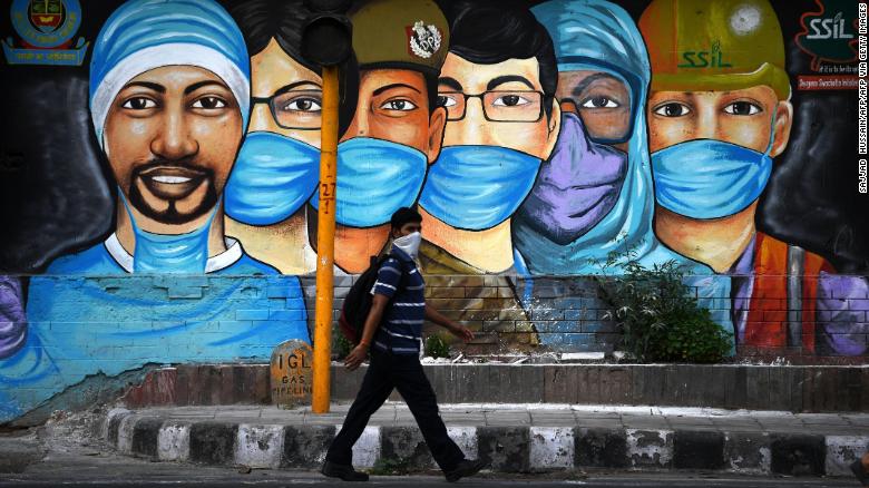 A man walks past a mural of frontline workers after the government eased a nationwide coronavirus lockdown in New Delhi on July 14.