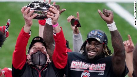 Ohio State head coach Ryan Day, left, holds the trophy alongside running back Trey Sermon after defeating Northwestern in the Big Ten championship game in Indianapolis, Indiana, on Saturday.