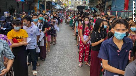 People stand in lines to get COVID-19 tests in Samut Sakhon, South of Bangkok, Thailand.