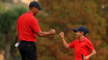 Tiger fist bumps Charlie on the 18th hole of the final round of the PNC Championship.