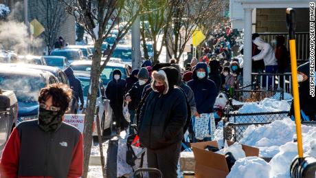 Hundreds of people in need wait in line to receive toys and food at the Grace Food Pantry&#39;s Christmas event in Everett, Massachusetts on December 19, 2020. - The pantry has been running seven days a week since the pandemic started and provided thousands of families with the food they need to survive. (Photo by Joseph Prezioso / AFP) (Photo by JOSEPH PREZIOSO/AFP via Getty Images)