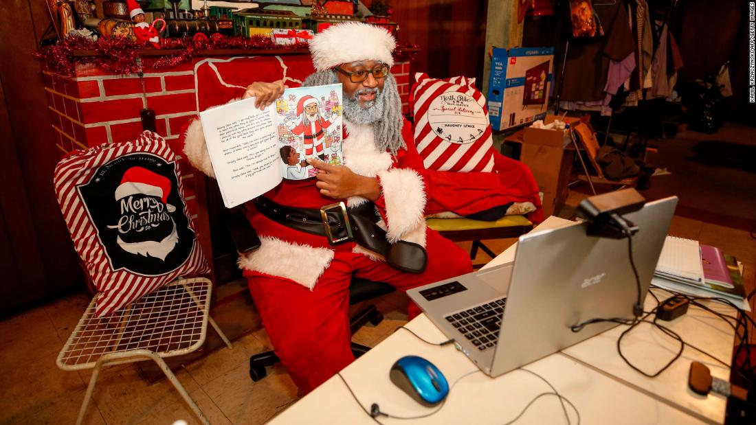 Andre Russel, dressed as Santa Claus, speaks to children from the basement of his Chicago home on December 17. Because of the pandemic, some children&#39;s visits with Santa Claus went virtual this year.