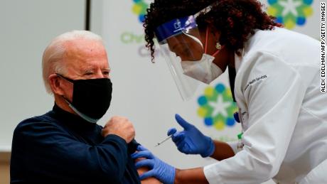 US President-elect Joe Biden receives a Covid-19 vaccination from Tabe Masa, Nurse Practitioner and Head of Employee Health Services, at the Christiana Care campus in Newark, Delaware on December 21, 2020.